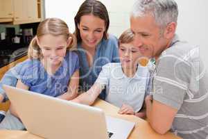 Lovely family using a notebook
