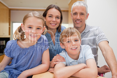 Family posing in a kitchen