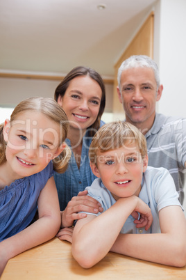 Portrait of a cute family posing in a kitchen