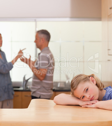 Portrait of a sad girl listening her parents arguing
