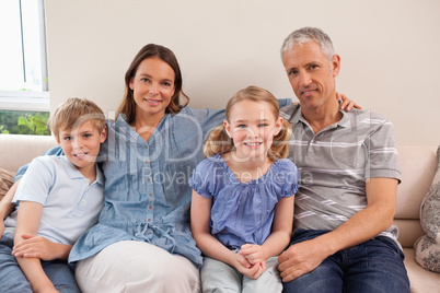 Happy family sitting on a sofa