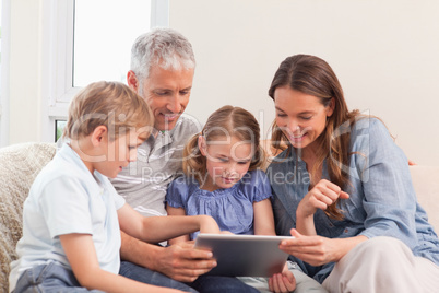 Happy family using a tablet computer