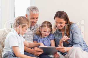 Happy family using a tablet computer