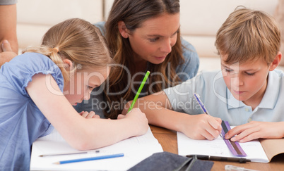 Mother helping her children to do their homework