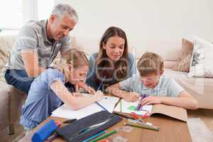 Parents helping their children to do their homework