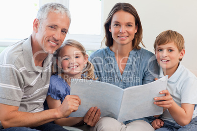 Happy family reading a book together