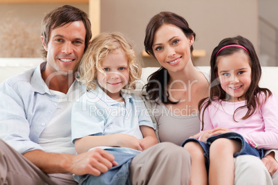 Happy family watching television together