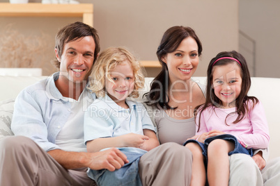 Cute family watching television together