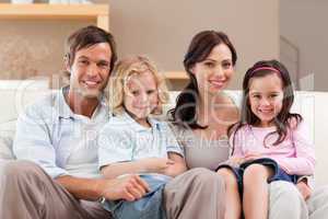 Cute family watching television together
