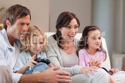 Cheerful family playing video games together