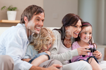 Delighted family playing video games together