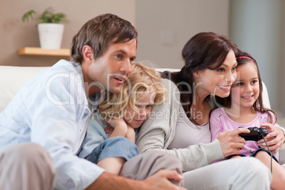 Playful family playing video games together