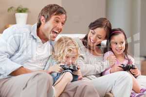 Laughing family playing video games