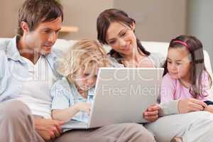 Calm family using a laptop