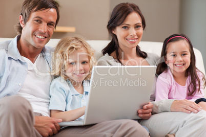 Calm family using a notebook