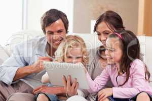 Delighted family using a tablet computer