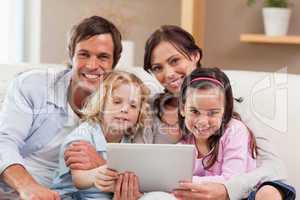 Charming family using a tablet computer