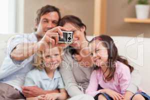 Happy father taking a picture of his family