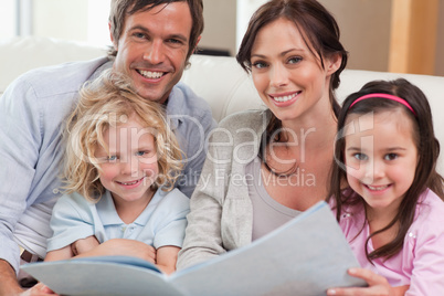 Close up of a family looking at a photo album