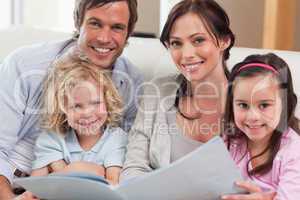 Close up of a family looking at a photo album