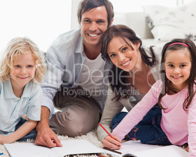 Smiling family drawing together