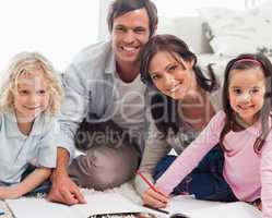 Smiling family drawing together