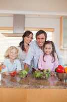 Portrait of a family preparing a salad