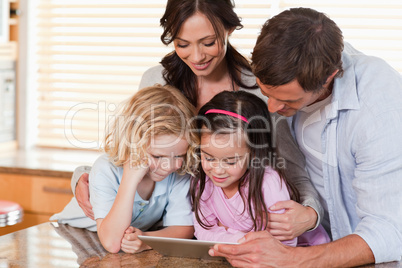 Happy family using a tablet computer together