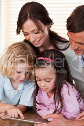 Portrait of a family using a tablet computer together