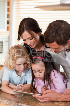 Portrait of a happy family using a tablet computer together