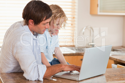 Boy and his father using a laptop together