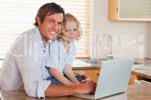 Boy and his father using a notebook together