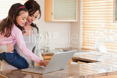 Girl and her mother using a laptop