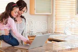 Girl and her mother using a laptop