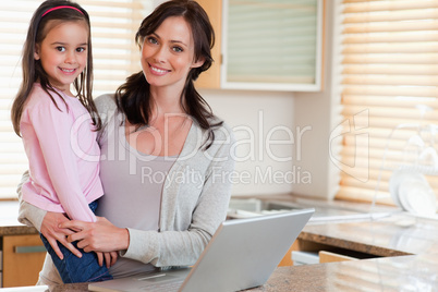 Girl and her mother using a notebook
