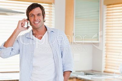 Smiling man making a phone call