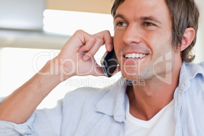 Close up of a smiling man making a phone call