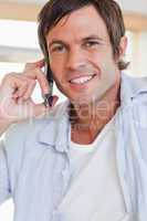 Portrait of an attractive man making a phone call