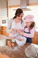 Portrait of a mother and her happy daughter baking