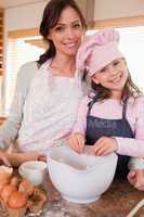 Portrait of a mother baking with her daughter