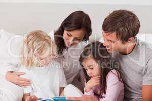 Lovely family reading a book