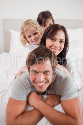 Portrait of a family lying on each other