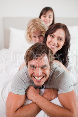 Portrait of a playful family lying on each other