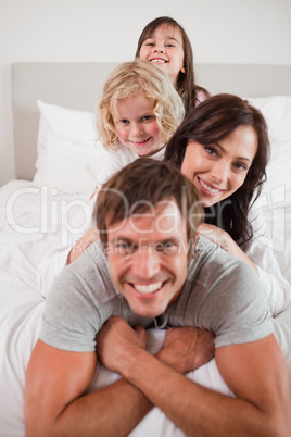 Portrait of a happy family lying on each other