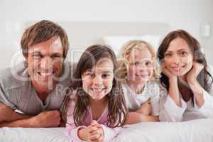 Family lying in a bed
