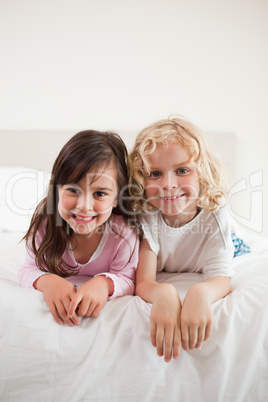 Portrait of siblings lying on their bellies