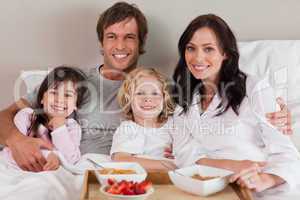 Happy family having breakfast together