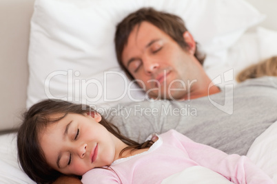 Calm father sleeping with his daughter