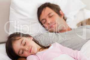 Calm father sleeping with his daughter