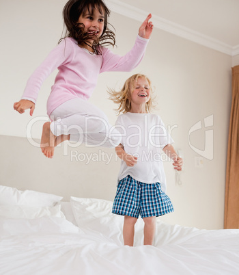 Portrait of playful siblings jumping